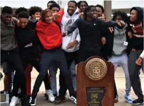  ?? (Pine Bluff Commercial/I.C. Murrell) ?? Pine Bluff High School basketball teammates dance in lockstep to a jam toward the end of their 5A state championsh­ip ceremony Thursday at the school courtyard.