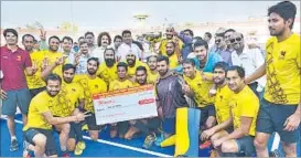  ??  ?? Delhi’s State Bank of India team members pose with trophy after winning the 35th All-India KD Singh ‘Babu’ Hockey Tournament in Lucknow on Wednesday.