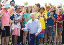  ?? ALEX BRANDON/ASSOCIATED PRESS ?? President Joe Biden tours King Orchards fruit farm in Central Lake, Mich., on Saturday. He pitched his immigratio­n plans while talking with two couples from Guatemala who were picking fruit.