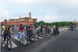  ?? — PTI ?? Youngsters pose with their bicycles at Raisina Hills during Unlock 3.0 in New Delhi on Sunday.