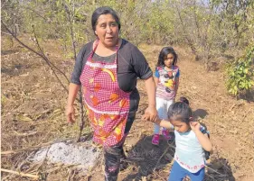  ?? ANGELA KOCHERGA/JOURNAL ?? Martina Alvarez walks through her family’s peach orchard with her grandchild­ren. Alvarez and her husband also grow corn and have a small tortilla shop in Cienega Grande, Guatemala.