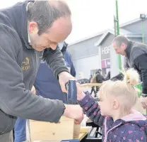  ??  ?? ●● Cheshire East Ranger Martin James helps Minnie Bamford