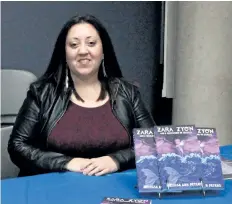  ?? LAURA BARTON/WELLAND TRIBUNE ?? Melissa Ann Peters, from Welland, is one of many local authors with a table at Welland Civic Square on Saturday afternoon during Local Author Day hosted by Welland Public Library. The event featured the writers and gave them a chance to connect with...