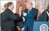  ?? SHAWN THEW/EPA ?? President Donald Trump congratula­tes Secretary of State Mike Pompeo at a Wednesday swearing-in ceremony.