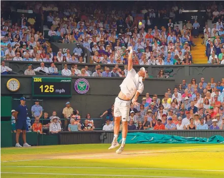  ?? GLYN KIRK/ASSOCIATED PRESS ?? South Africa’s Kevin Anderson fires a serve toward John Isner in their 6-hour, 36-minute men’s semifinal match Friday at Wimbledon. The eighth-seeded Anderson from South Africa won the final set, 26-24 — a set that took nearly three hours to finish.