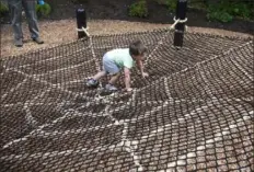  ?? Pittsburgh Post-Gazette ?? Logan Diethorn, 2, of Mount Washington, plays on the spider web in the new Garden of the Five Senses at the Pittsburgh Botanic Garden in North Fayette and Collier.