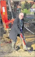  ??  ?? Cllr Ken Mulholland turns the sod to mark the beginning of work on Smarden Post Office