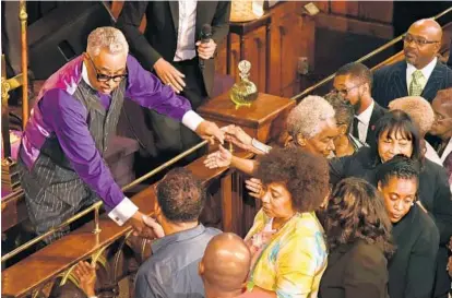  ?? AMY DAVIS/BALTIMORE SUN PHOTOS ?? Bethel AME Church on Druid Hill Avenue was packed with well-wishers who came forward to shake hands with the Rev. Frank M. Reid III after he delivered his last sermon at the historic church. Reid served for 28 years.