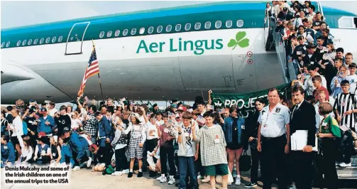  ??  ?? Denis Mulcahy and some of the Irish children on one of the annual trips to the USA