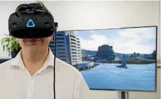  ?? PHOTO: ROSA WOODS/STUFF ?? Wellington City Council innovation officer Sean Audain tries out a new virtual reality headset that shows what climate change could mean for Wellington.