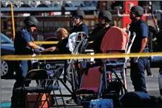  ?? FRANCINE ORR/LOS ANGELES TIMES ?? A woman has her vitals checked at the triage area on Saturday during a hostage situation, after a police pursuit ended near the Trader Joe’s in Silver Lake.