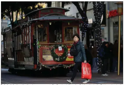  ?? (AP) ?? Decked-out streets and bustling shoppers are seen in San Francisco in November. Retailers planning for Christmas shopping this year are taking into account the need for coronaviru­s precaution­s, experts say.
