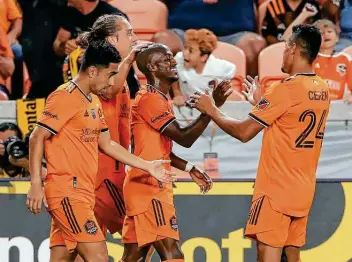  ?? Michael Wyke / Associated Press ?? The Dynamo's Fafa Picault, center, greets teammates Memo Rodriguez, Griffin Dorsey and Darwin Ceren after his second goal against Austin on Saturday, when the Dynamo broke a 16-game winless streak.