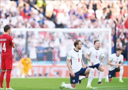  ?? ?? Harry Kane and England team mates take the knee before their semi-final match against Denmark in the Euro 2020 at Wembley