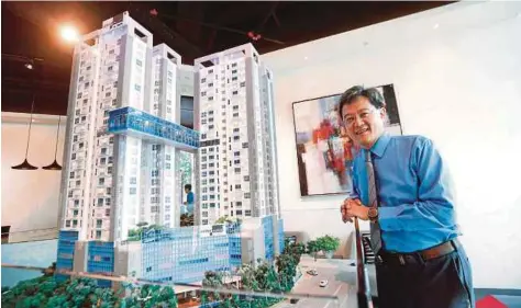  ??  ?? Bukit Kiara Properties group managing director with a scale model of VERVE Suites KL South.