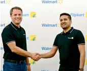  ??  ?? Walmart Inc CEO Doug McMillon with Flipkart CoFounder and CEO Binny Bansal in Bengaluru during the takeover. The US retail behemoth had announced that it was acquiring a 77 per cent stake in India’s largest ecommerce firm for about $16 billion (`1.05...