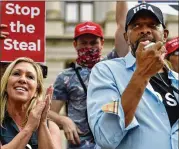  ?? MIKE STEWART/ AP ?? Republican Congresswo­man- electMarjo­rie Taylor Greene of northwest Georgia applauds as State Rep. Vernon Jones speaks at a rally of Trumpsuppo­rters in Atlanta on Saturday.