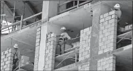 ?? AP/ALAN DIAZ ?? Bricklayer­s work on an apartment high-rise in Miami in May. The Commerce Department said Thursday that the U.S. economy grew at an annual rate of 3.1 percent in the spring.
