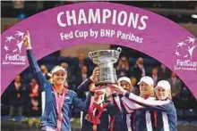  ?? AP ?? United States’ team celebrate after winning the Fed Cup after 17 years on Sunday. The US beat Belarus 3-2.