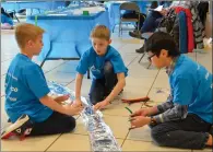  ?? NEWS PHOTO MO CRANKER ?? Theo Coombs, James Comstock and Morgan Gill discuss the next steps of making an aqueduct Saturday afternoon during the APEGA Science Olympics.