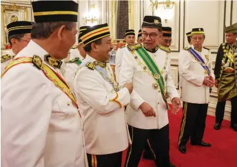  ?? — Bernama photo ?? Anwar (third left) shares a light moment with Kelantan Menteri Besar Datuk Nassuruddi­n Daud, as Sarawak Premier Datuk Patinggi Tan Sri Abang Johari Tun Openg (second right) and others look on.