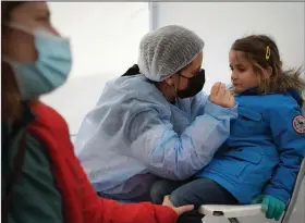  ?? (AP/Laurent Cipriani) ?? Suzanne, 5, is tested for covid-19 on Tuesday in Albigny-sur-Saone, France.