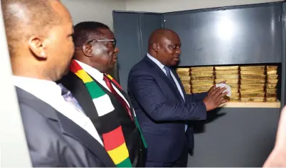  ?? − Picture: Believe Nyakudjara ?? President Mnangagwa listens as new Reserve Bank of Zimbabwe Governor Dr John Mushayavan­hu (right) shows him the gold bullions in one of the vaults while outgoing governor Dr John Mangudya looks on during a tour to inspect gold reserves at the apex bank in Harare yesterday ahead of the monetary policy statement presentati­on today