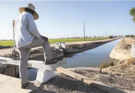  ?? Mario Tama / Getty Images 2020 ?? Adolfo, a documented migrant worker who lives in Mexico, helps irrigate an alfalfa field in July in Imperial County, which is making strides against the virus.