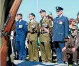  ??  ?? Service men pay their respects at the Armistice Day Remembranc­e service at the Invercargi­ll Cenotaph yesterday.