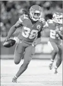  ?? David Eulitt Getty Images ?? THE CHIEFS’ Ron Parker returns an intercepti­on 33 yards for a touchdown.