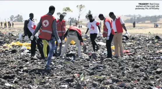  ?? Pic: AFP/Getty ?? TRAGEDY Red Cross workers at the crash site yesterday.