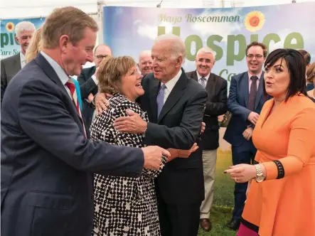  ??  ?? Former US vice president Joe Biden embraces Fionnuala Kenny, wife of former Taoiseach Enda Kenny, who is greeted by Martina Jennings, CEO of Mayo Roscommon Hospice Foundation, at the sod-turning for the new Mayo Roscommon Hospice Facility in Castlebar,...