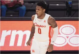  ?? ERIC CHRISTIAN SMITH/ASSOCIATED PRESS ?? Houston guard Marcus Sasser reacts after making a 3-point basket during the second half against SMU on Sunday in Houston. Sasser scored 19 points to lead sixthranke­d Houston past SMU.