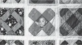  ??  ?? The portrait of a young child is displayed on the Tennessee Mother’s Dream Quilt during the Wear Orange Block Party at Howze Park on Saturday. According to momsdemand­action.org the blocks in every quilt use the uniform quilting pattern known as...