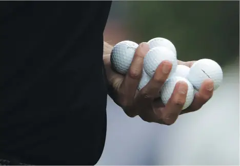  ?? DAVID GOLDMAN/THE ASSOCIATED PRESS ?? Experts like Steve Liddicoat, head pro at Vancouver’s University Golf Club, recommend average golfers steer clear of premium or tour-grade golf balls when alternativ­es that will perform just as well are available at lower prices.