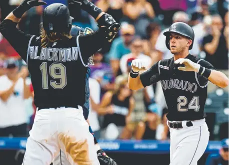  ?? Parker Seibold, The Associated Press ?? Rockies second baseman Ryan McMahon, right, celebrates with right fielder Charlie Blackmon during the third inning after hitting the first of his two home runs Sunday at Coors Field against the San Diego Padres.