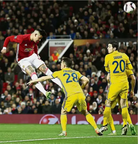  ??  ?? High energy: Manchester United’s Marcos Rojo attempts a header at the Rostov goal in the Europa League last 16 second leg at Old Trafford on Thursday. Below: United manager Jose Mourinho holding a banana which was later passed to Rojo. — Reuters