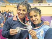  ?? PTI ?? Sakshi Malik (left) and Vinesh Phogat pose with their silver medals in New Delhi on Friday.