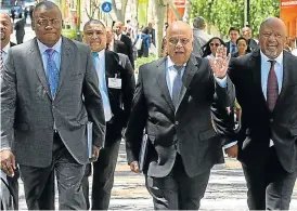  ?? /Business Day ?? D-day: Finance Minister Pravin Gordhan, flanked by Treasury director-general Lungisa Fuzile, left, and Deputy Finance Minister Mcebisi Jonas, arrives to present the budget in 2016.