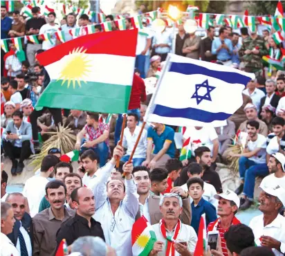  ?? (Reuters) ?? Orlando, Florida A KURDISH MAN holds Israeli and Kurdish flags during a rally in Erbil last week to show support for next Monday’s independen­ce referendum.