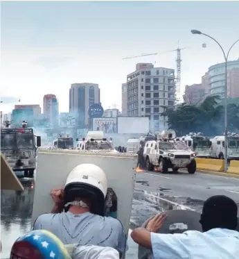  ?? Wikimedia photo ?? Protesters in Caracas face government troops near the Francisco Fajardo Highway, June 19, 2017.