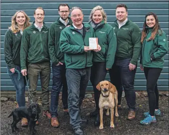  ??  ?? Glencoe Activities’ Laurence Young holds the award while surrounded by his family and, below, one of the luxury lodges at Woodlands Glencoe