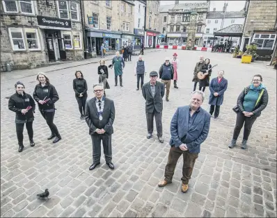  ?? PICTURE: TONY JOHNSON. ?? WELCOME BACK: Simon Raybould, chair of Otley Chamber of Trade, front left with Paul Carter, chair of Otley Town Council’s trade and tourism committee, front right, joined by traders set to reopen their doors as covid restrictio­ns are eased.