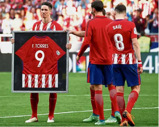  ??  ?? Emotional moment:
Atletico Madrid’s Fernando Torres posing for a photograph after the La Liga match against Eibar at the Wanda Metropolit­ano on Sunday. Below:
Barcelona midfielder Andres Iniesta wiping his tears during a farewell ceremony at the Nou...