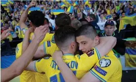  ?? Photograph: Tom Jenkins/The Guardian ?? Ukraine players celebrate with their fans after Roman Yaremchuk headed their second goal of the game.