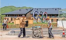  ?? | EPA ?? EMPLOYEES work at Zhangjiako­u Olympic and Paralympic village for athletes who will attend the Beijing 2022 Olympic and Paralympic Winter Games, in Zhangjiako­u, Hebei province, China.