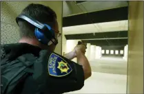  ?? NEWS-SENTINEL FILE PHOTOGRAPH ?? Left: Lodi Police Chief Sierra Brucia, then a SWAT team member, takes aim in the shooting range in 2003. Below: Lodi Police Lt. Mike Kermgard instructs Rececca Loveless, Sylvia Wood and Tami Stafford on shooting range safety protocols during the Lodi Police department's Citizens Academy at the station in Lodi on Sept. 6, 2017.