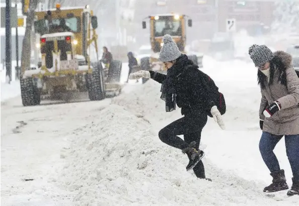  ?? DAVID BLOOM/FILES ?? Pedestrian­s make their way over windrows along 102 Avenue near 101 Street. The city’s new head of city operations, Doug Jones, and director of roadway maintenanc­e, Eduardo Sosa, plan to make a presentati­on to council about better ways to remove snow and ice.