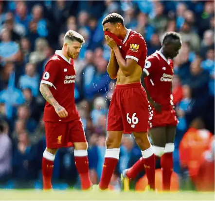  ?? — Reuters ?? In shambles: Trent Alexander-Arnold (centre) looking dejected after Liverpool conceded another goal in their 5- 0 loss to Manchester City on Sept 9.