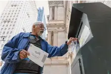  ?? Hannah Beier/New York Times ?? A voter mails a ballot last week in Philadelph­ia. The pandemic sped up the adoption of mail voting in Pennsylvan­ia.